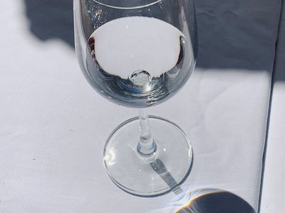 Glass of water reflecting light on a table