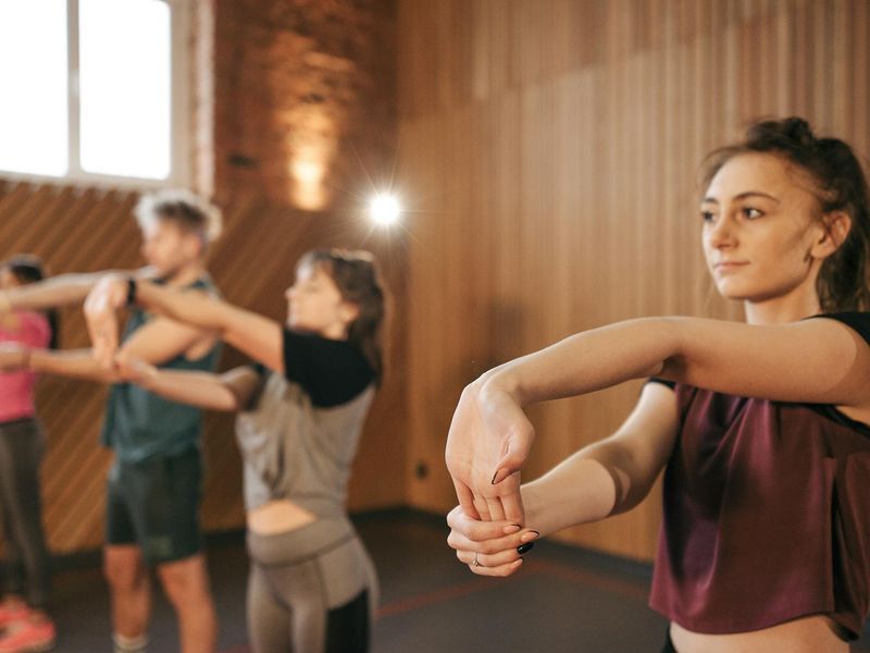 Person performing dynamic cardio exercises in a bright room